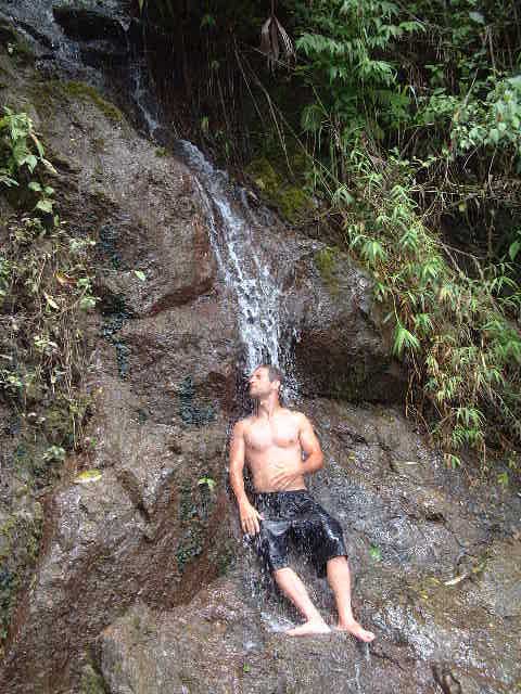 Ed in the waterfall by the road